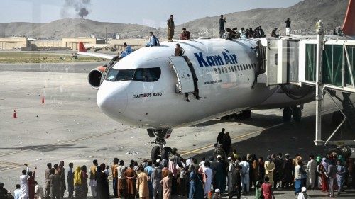 Afghan people climb atop a plane as they wait at the Kabul airport in Kabul on August 16, 2021, ... Afghan people climb atop a plane as they wait at the Kabul airport in Kabul on August 16, 2021, ...