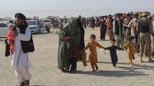 An Afghan family arrives at the Pakistan-Afghanistan border crossing point in Chaman on August 20, ...