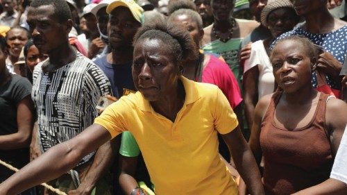 Camp-Perrin residents wait to receive food from the World Food Programme (WFP) in Camp-Perrin near ...