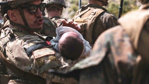 In this image courtesy of the US Central Command Public Affairs, A US Airmen comforts an infant ...