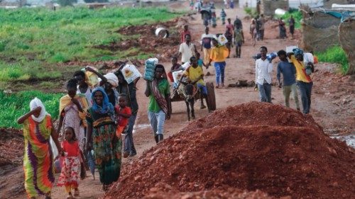 TOPSHOT - Ethiopian refugees who fled the fighting in the Tigray region transport jerrycans of water ...