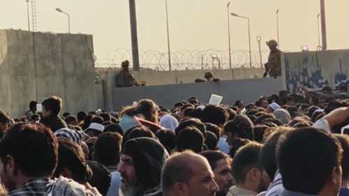 epa09426151 People attempt to get into the Hamid Karzai International Airport, to flee the country, ...