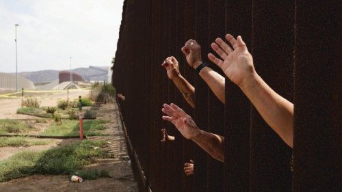 epaselect epa09425596 A group of people wave to the side of the United States border on the beaches ...