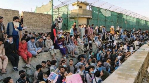 Crowds of people wait outside the airport in Kabul, Afghanistan August 25, 2021 in this picture ...