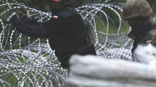 Polish soldiers construct a barbed wire fence on the border with Belarus in Zubrzyca Wielka near ...