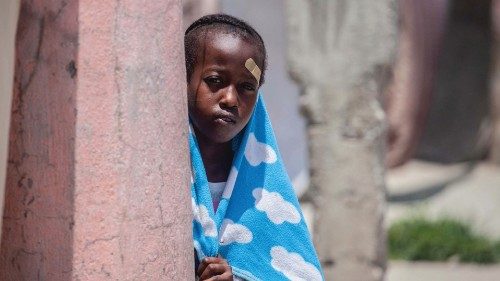 A boy looks on at a camp for people who lost their home during the August 14 earthquake in Les ...