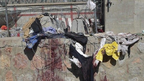 Clothes and blood stains of Afghan people who were waiting to be evacuated are seen at the site of ...