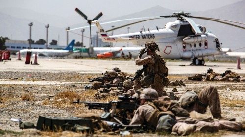 U.S. Marines keep watch during an evacuation at Hamid Karzai International Airport, Kabul, ...