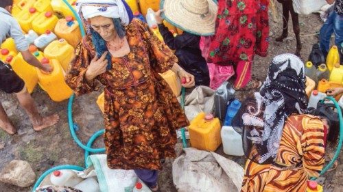 Yemeni women fill their jerricans with water from a tanker in the southwestern Taez Governorate's ...