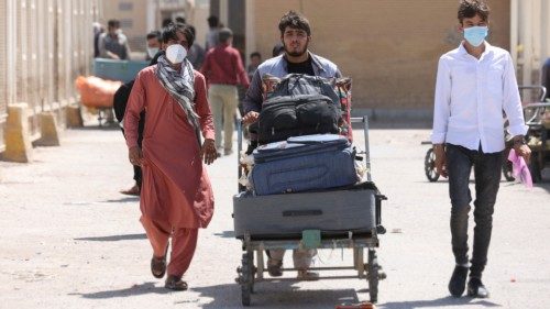 Afghan nationals enter Iran at the Dowqarun border crossing between Iran and Afghanistan, Razavi ...