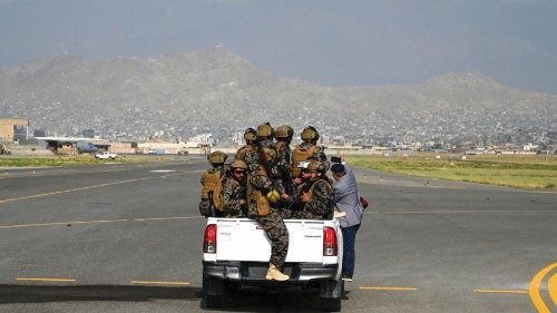 Members of the Taliban Badri 313 military unit ride a vehicle on the runway of the airport in Kabul ...
