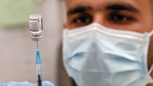 A health worker prepares a dose of the Pfizer-BioNtech COVID-19 coronavirus vaccine at the Clalit ...