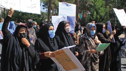 Afghan women hold placards as they take part in a protest in Herat on September 2, 2021. - Defiant ...