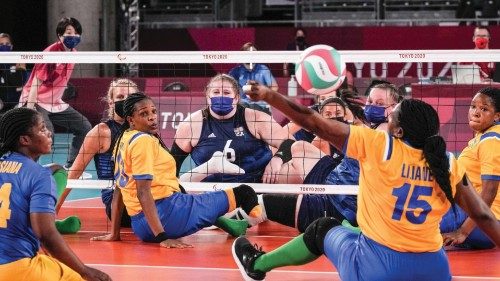 Rwanda's Liliane Mukobwankawe (2nd R) receives a ball during a sitting volleyball pool match between ...