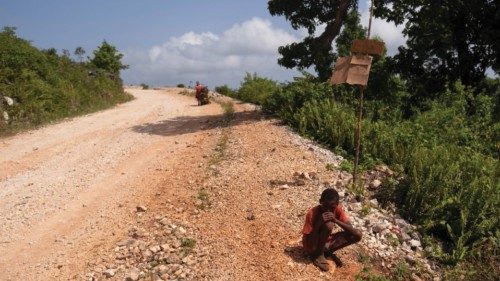 A boy sits on the side of a road near a tent encampment built after the August 14 earthquake ...