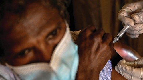 A Police health worker inoculates a man with a dose of the Sinopharm vaccine against the Covid-19 ...