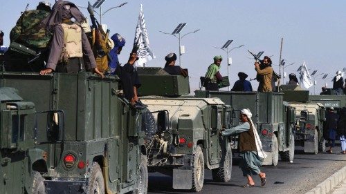 TOPSHOT - Taliban fighters atop Humvee vehicles prepare before parading along a road to celebrate ... TOPSHOT - Taliban fighters atop Humvee vehicles prepare before parading along a road to celebrate ...