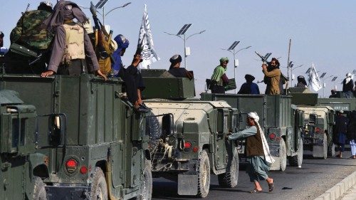 TOPSHOT - Taliban fighters atop Humvee vehicles prepare before parading along a road to celebrate ...