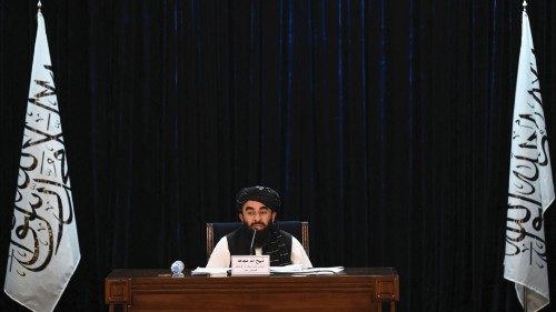 TOPSHOT - Taliban spokesman Zabihullah Mujahid addresses a press conference in Kabul on September 7, ...