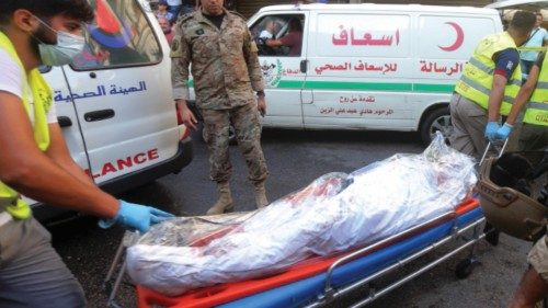 TOPSHOT - Medics evacuate a body from the site of a factory explosion in the Burj al-Barajneh area ...