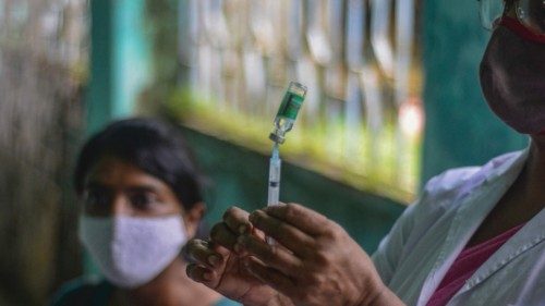 A health worker (R) prepares a dose of Covishield vaccine against the Covid-19 coronavirus at a ...