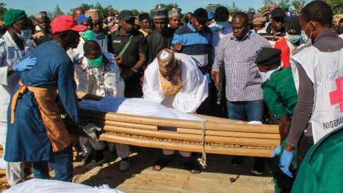 Mourners attend the funeral of 43 farm workers in Zabarmari, about 20km from Maiduguri, Nigeria, on ...