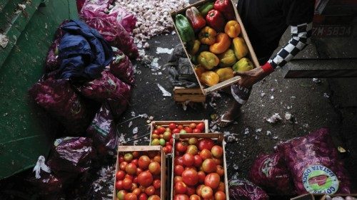 People scavenge through thrown away food to find eatable or saleable products at the supply centre ...