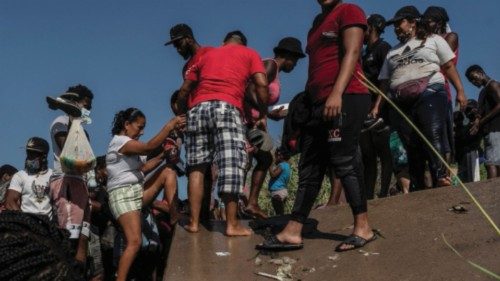 Migrants seeking asylum in the U.S. walk in the Rio Grande river near the International Bridge ...