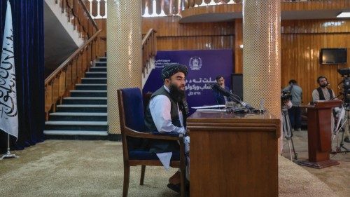 Zabihullah Mujahid, Chief spokesman for the Taliban, speaks during a press conference with the ...