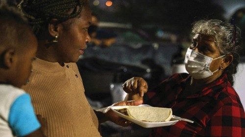 TOPSHOT - Mari Jaona gives Haitian Naomi and her son David, 3, a plate of food in Parque Ecologico ... TOPSHOT - Mari Jaona gives Haitian Naomi and her son David, 3, a plate of food in Parque Ecologico ...