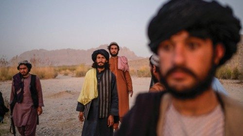 In this picture taken on September 23, 2021, Taliban members enjoy an afternoon on the banks of a ...