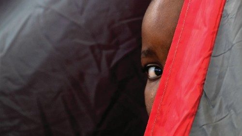 TOPSHOT - A Haitian boy peers from inside a tent at the Terraza Fandango shelter, in Ciudad Acuna, ...