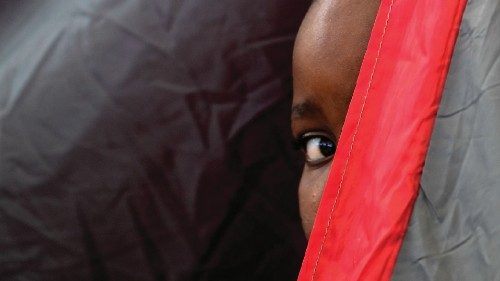 TOPSHOT - A Haitian boy peers from inside a tent at the Terraza Fandango shelter, in Ciudad Acuna, ... TOPSHOT - A Haitian boy peers from inside a tent at the Terraza Fandango shelter, in Ciudad Acuna, ...