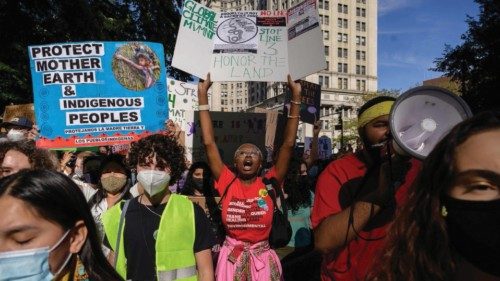 Climate activists hold placards and shout slogans as they attend a march as part of a 'Global Youth ...