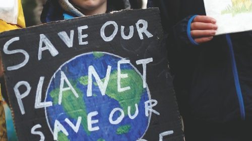 FILE PHOTO: A child carries a sign during an Extinction Rebellion demonstration in London, Britain, ...