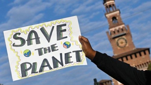 A demonstrator holds up a sign as he attends a Fridays for Future climate strike while environment ...