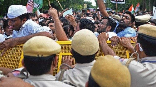 India's Congress party activists shout slogans from behind a police barricade during a demonstration ...
