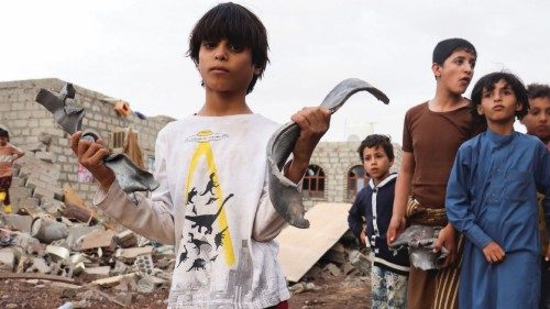A boy holds shrapnel of a missile at the site of Houthi missile attack in Marib, Yemen, October 3, ...