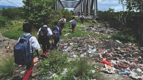 Pupils walk to a bridge after school in a remote village in Panca, Aceh province on September 29, ...