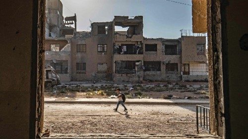TOPSHOT - A Syrian student walks to school past damaged buildings in the northern city of Raqqa, on ...
