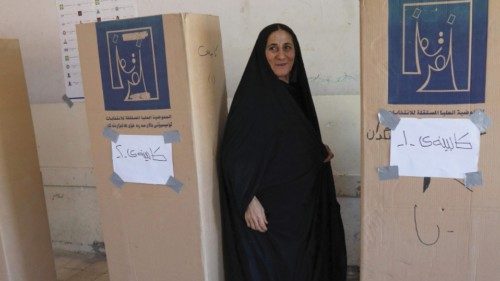 TOPSHOT - An Iraqi Kurdish woman registers before voting in early parliamentary elections at a ...