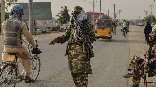 Taliban fighters check commuters along a road in Kunduz on October 10, 2021. (Photo by Hoshang ...