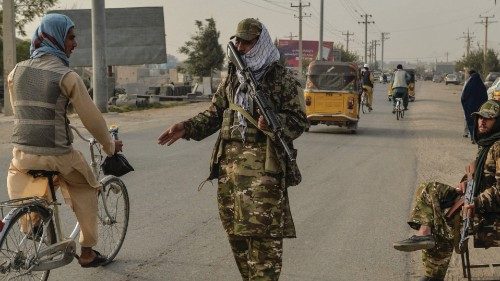 Taliban fighters check commuters along a road in Kunduz on October 10, 2021. (Photo by Hoshang ... Taliban fighters check commuters along a road in Kunduz on October 10, 2021. (Photo by Hoshang ...