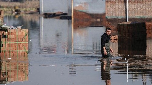 A man makes his way along a flooded area after heavy rainfall in Jiexiu in the city of Jinzhong in ...