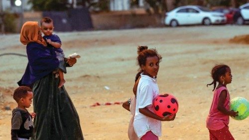 African migrant children and a woman are pictured at a makeshift shelter in the capital Tripoli's ...