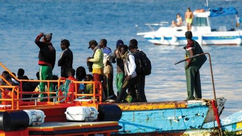 Migrants wait to disembark from a boat towed by a Spanish coast guard vessel, in the port of ...