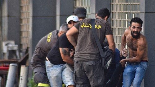 Lebanese civil defence members and others evacuate a fallen person amidst clashes in the area of ... Lebanese civil defence members and others evacuate a fallen person amidst clashes in the area of ...