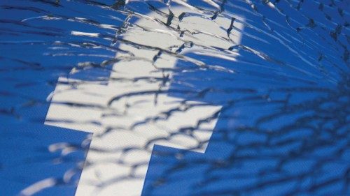 FILE PHOTO: Facebook logo displayed through broken glass in this illustration taken October 4, 2021. ...