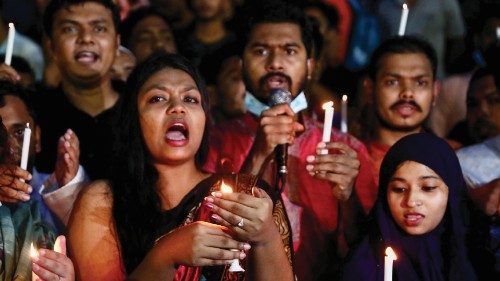 Students of the University of Dhaka join in a torch procession demanding justice for the violence ...