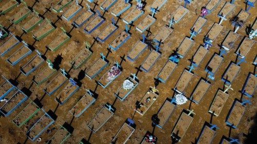 (FILES) In this file photo taken on April 15, 2021 aerial view of graves of COVID-19 victims at the ...